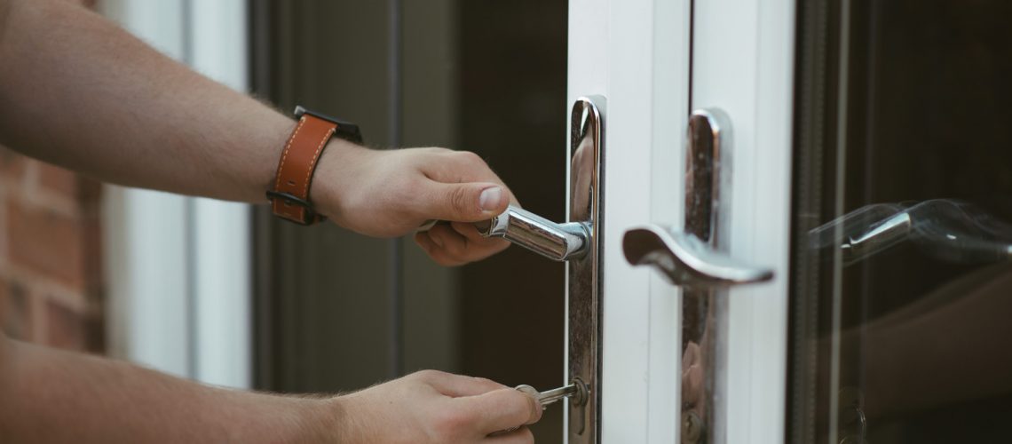 Canva - Person Holding Door Lever and Key