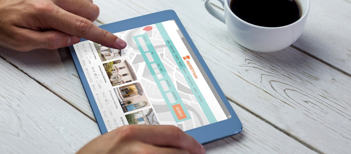 Composite image of property web page against person using tablet