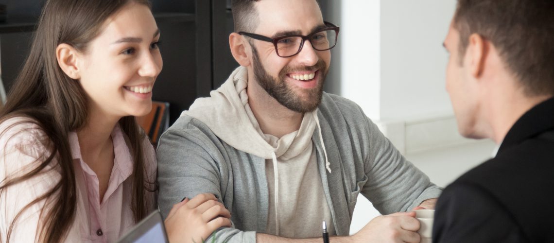 Excited Smiling Millennial Couple Discussing Mortgage Loan Inves